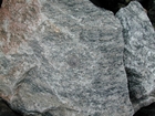 I 26 Tn NC border Metamorphics - Rip rap fill - loose block of Foliated Granite characterized by dark minerals that include amphiboles, biotite mica and white minerals which are a mix of feldspars and quartz