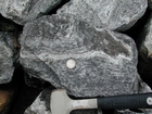 I 26 Tn NC border Metamorphics - Rip rap fill - loose block of Foliated Gneiss characterized by dark minerals that include amphiboles, biotite mica and white minerals which are a mix of feldspars and quartz