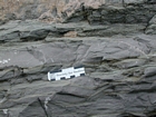 Photograph featuring wave dominated hummocky cross-bedded and thin-bedded irregular and lenticular-bedded shallow water packstones and mudstones of the Lower Mississippian Newman Limestone Formation interpreted to have accumulated just seaward of a shore face within wave base. This is unit 108 of the measured Geological Section, Kentucky Geological Survey Field Trip Guide, 1998