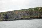 Kilclogher Cliffs exposing deepwater sandstone lobes of the Ross Formation. At the base of the section are thinner bedded more distal portions of lobes subdivided by a dense amalgamated lobe of sand. Above in grass cover are thicker bedded channeled sands more proximal to the axies of deepwater lobes.