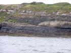 Kilcredaun Cliffs in the vicinity of the Kilcredaun lighthouse. Outcropping in these cliffs are thin bedded turbidite channel fill and turbidite sand lobes in the Upper Carboniferous Namurian Ross Formation. Photographs taken from the fishing vessel Draiocht out of Carrigaholt on the northern shore of the Shannon Estuary.