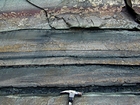 Alternating lenticular sheets of sand and shale that accumulated within fining upward deepwater turbidite fans with sparse channeling expressed by cut and fill.